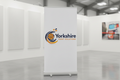 Custom printed roller banner stand in a modern office with Yorkshire Print Solutions branding