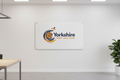 Custom printed Foamex board mounted on a wall in a modern office with Yorkshire Print Solutions branding
